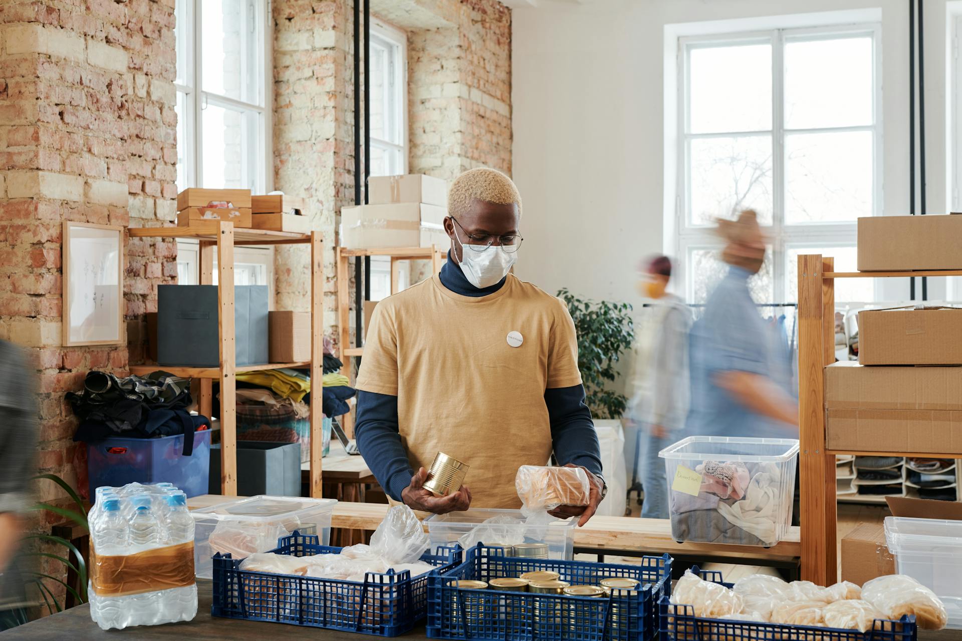 A Volunteer Wearing a Face Mask Preparing Donations