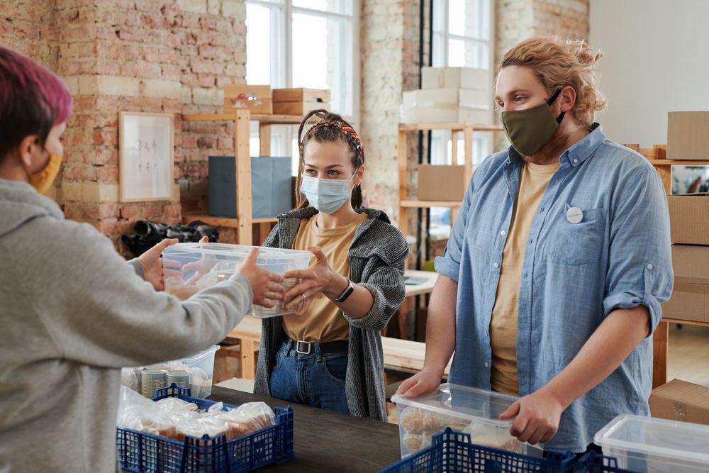 Volunteers handing out food donations at a charity drive