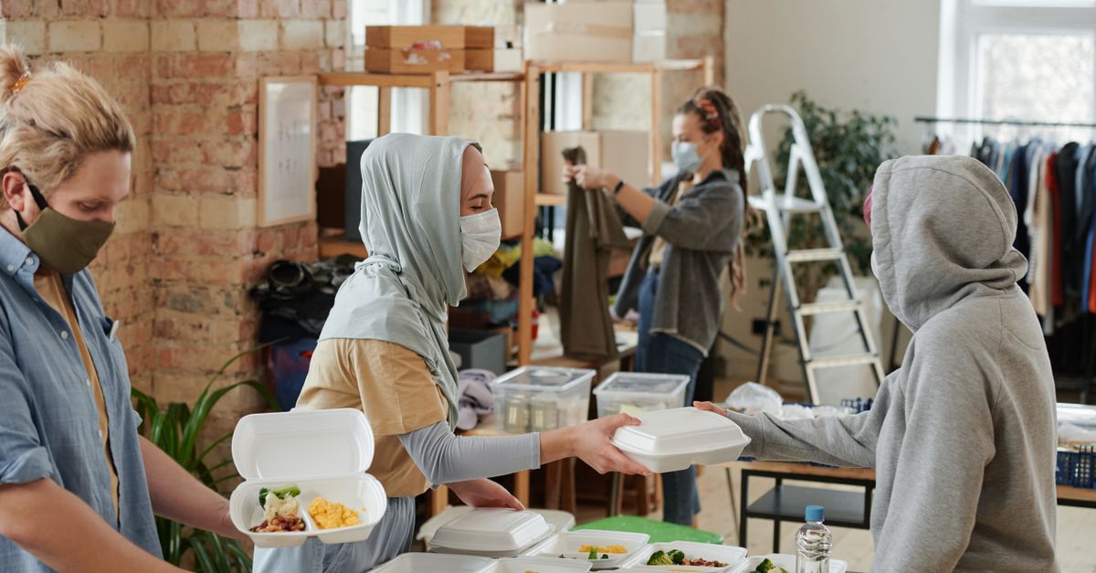 hands serving meal to neighbor kitchen volunteer anonymous kindness