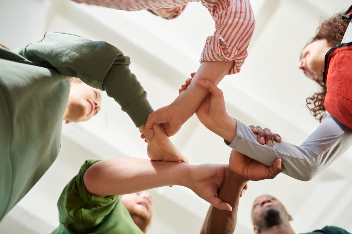 Group of diverse people in supportive circle conversation