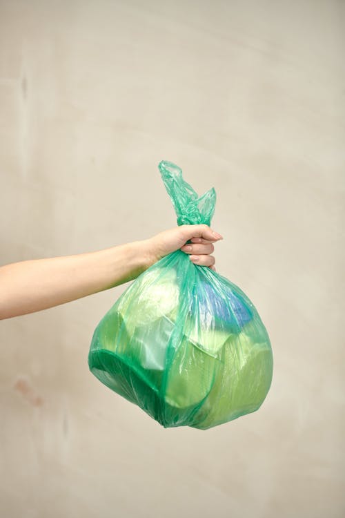 Free Person Holding Plastic Bag with Garbage Stock Photo