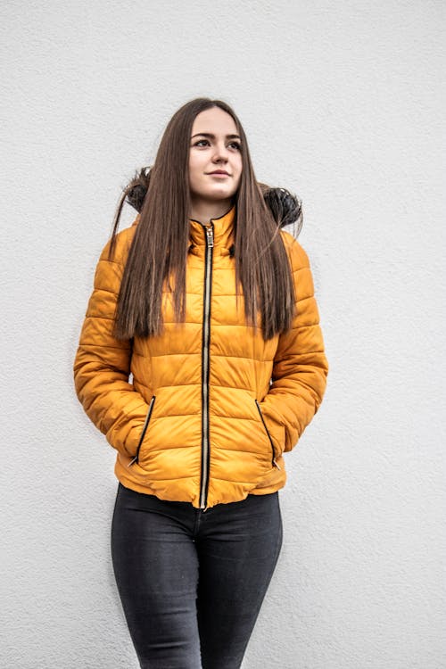 Woman Wearing Yellow Jacket with Hands in Pockets