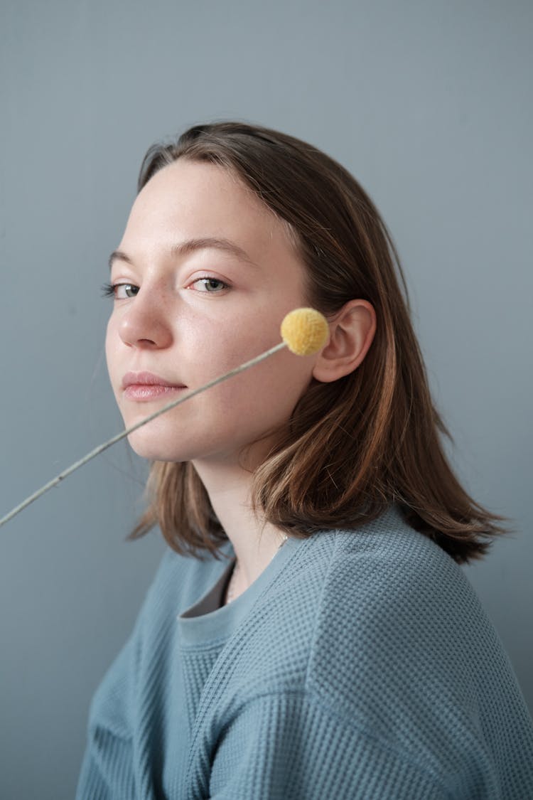 Young Woman With Pompom On Stick