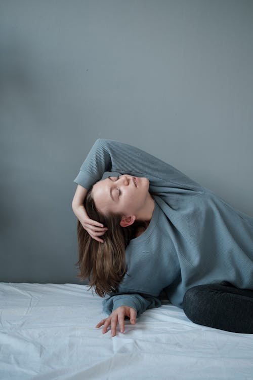 Young woman with closed eyes on bed