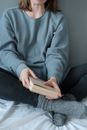 Person in Blue and White Pinstripe Dress Shirt Holding Brown Book
