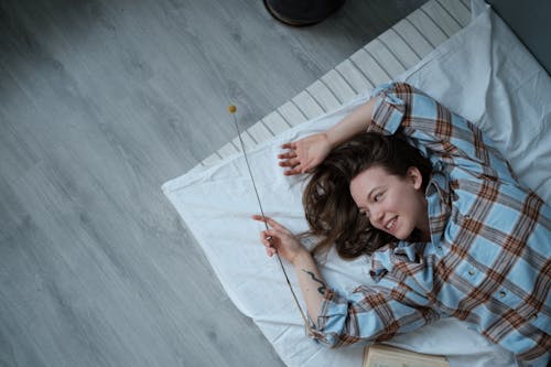 Free Girl Lying on Blue and White Plaid Blanket Stock Photo