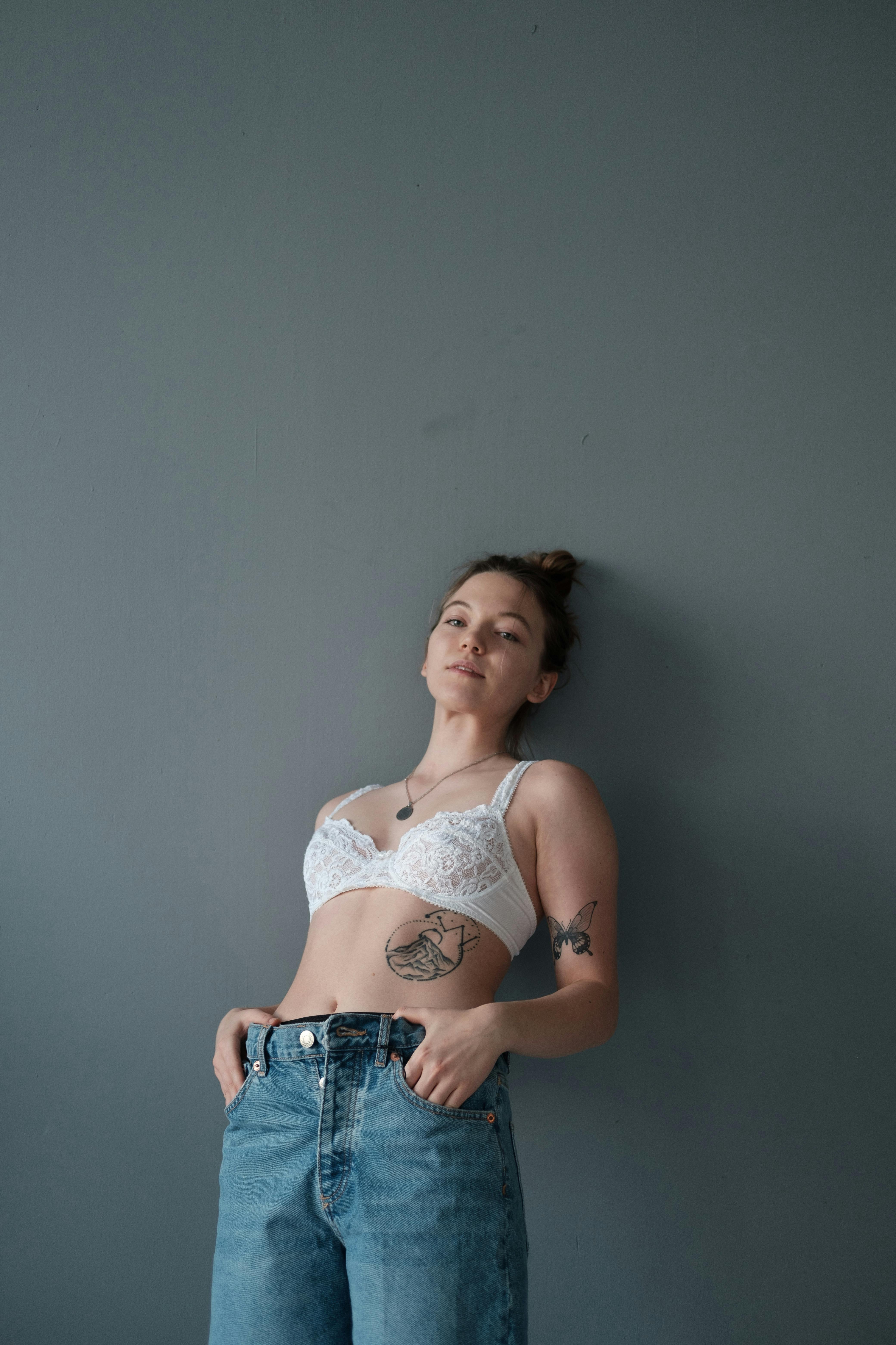 Woman in a White Brassiere Posing with Her Hands in Her Pockets · Free Stock  Photo