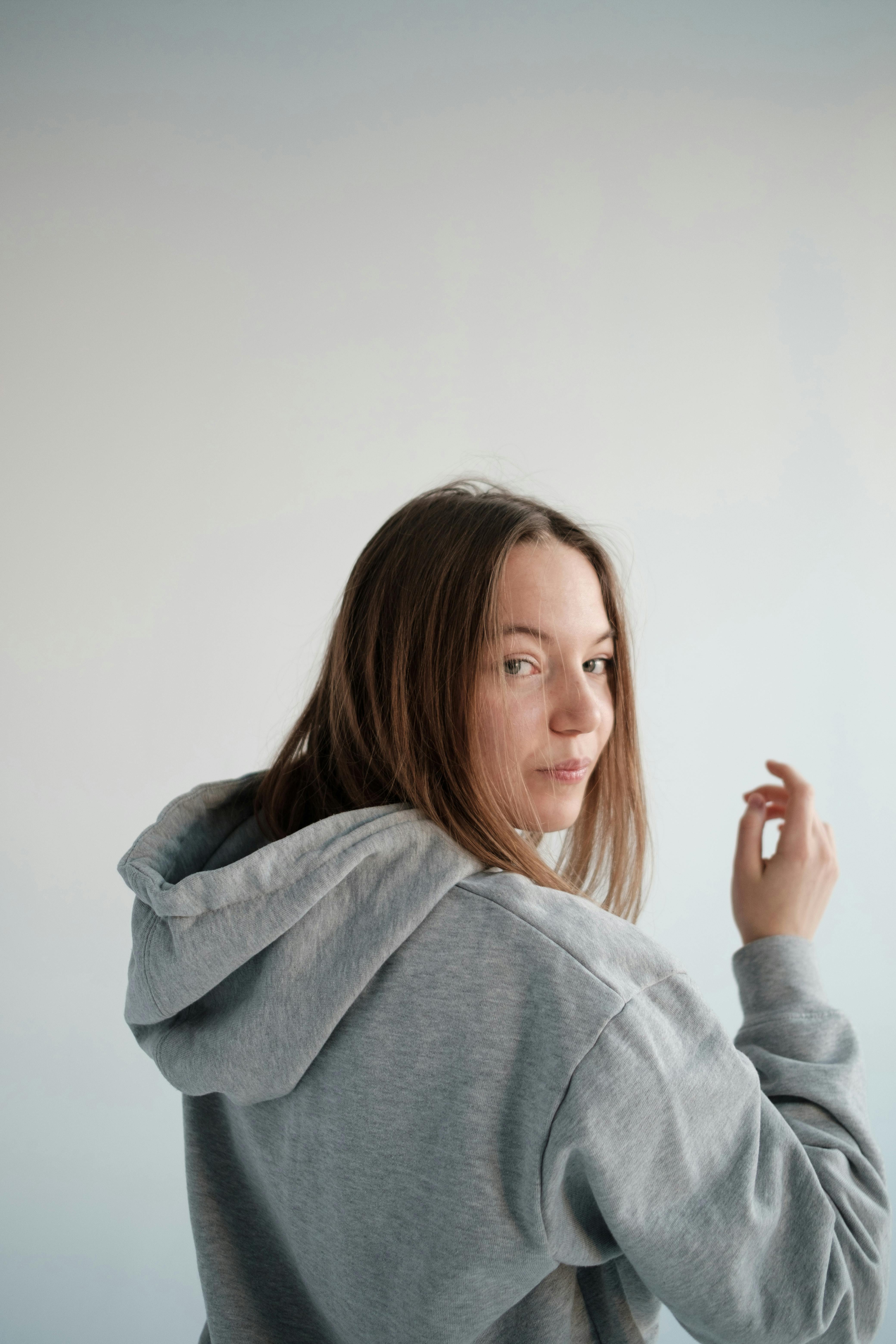 Young woman in gray hoodie · Free Stock Photo