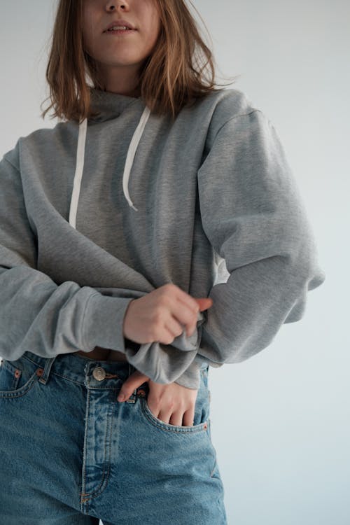 Stylish woman wearing gray hoodie