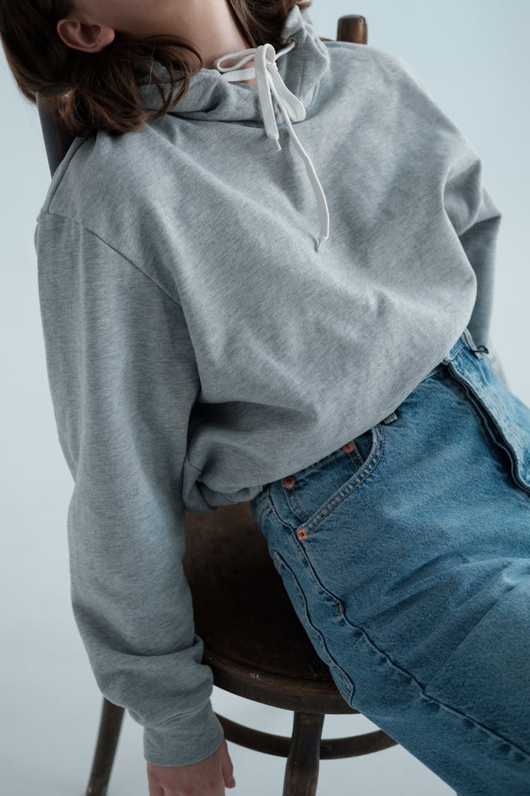 Relaxed Woman Sitting On Chair In Studio