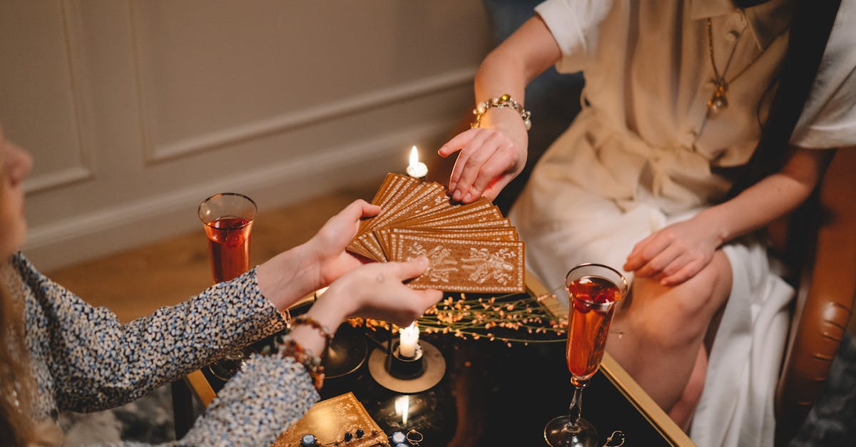 Two women engaged in a mystical tarot card reading session in a cozy indoor setting.