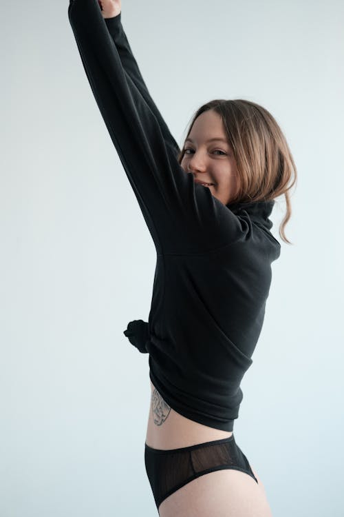 Slim woman in underwear raising arms · Free Stock Photo