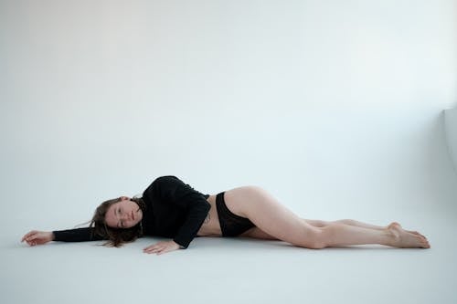 Fit woman lying on floor in studio