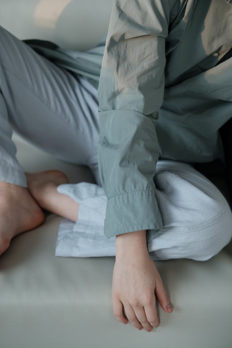 Barefoot Woman In Linen Outfit On Couch