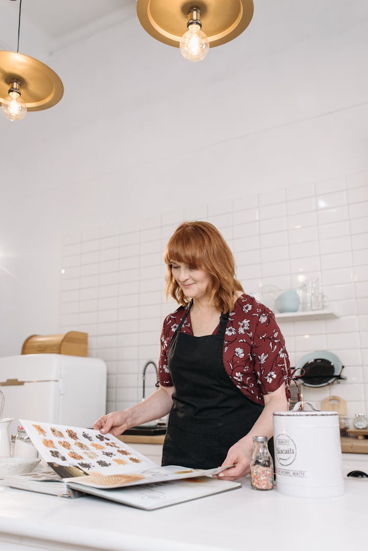 A Woman Looking On A Cook Book