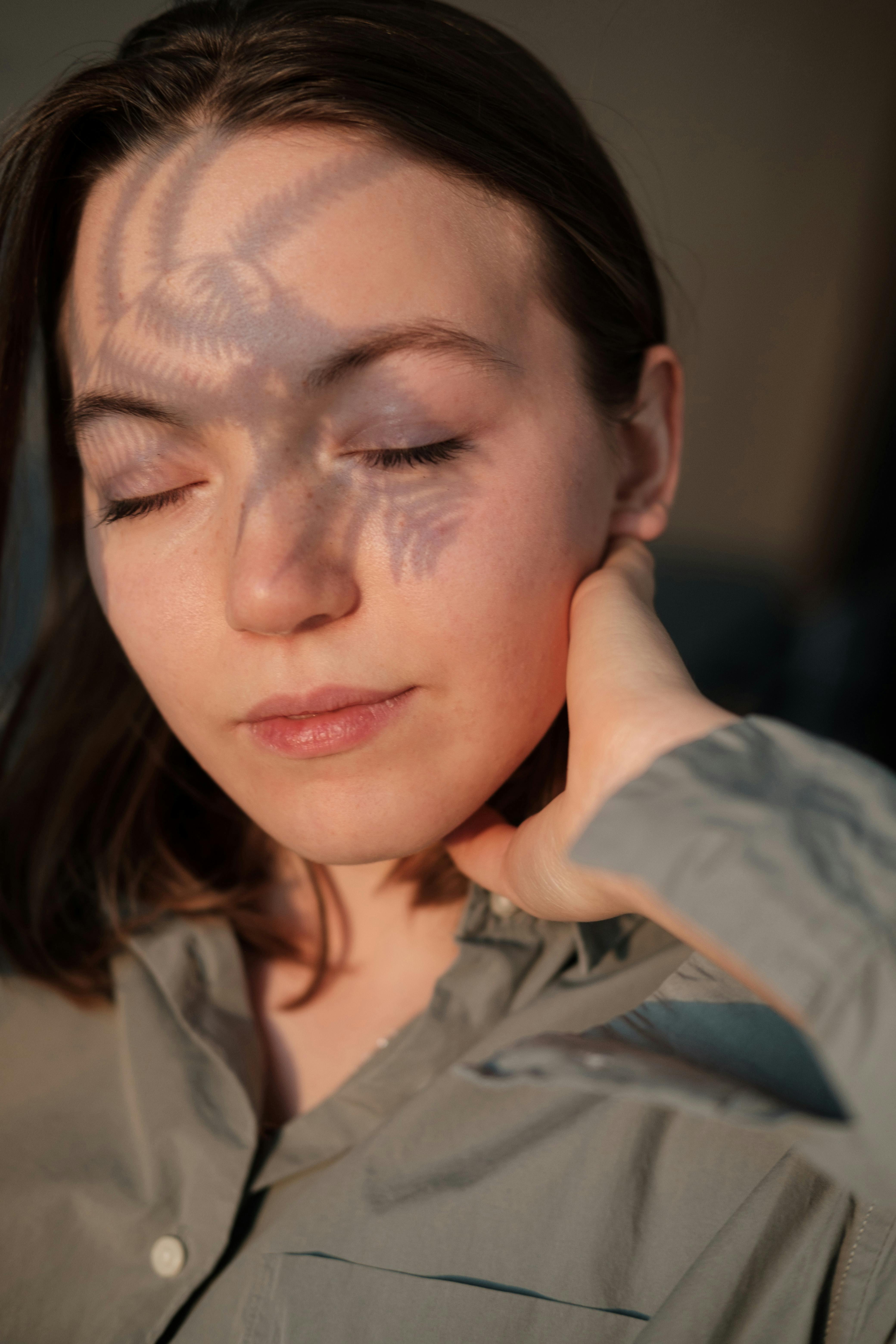 peaceful female with closed eyes in sunlight