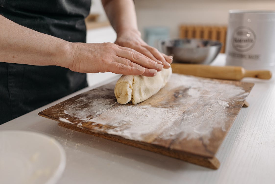 Free Person Holding Dough on Brown Wooden Table Stock Photo