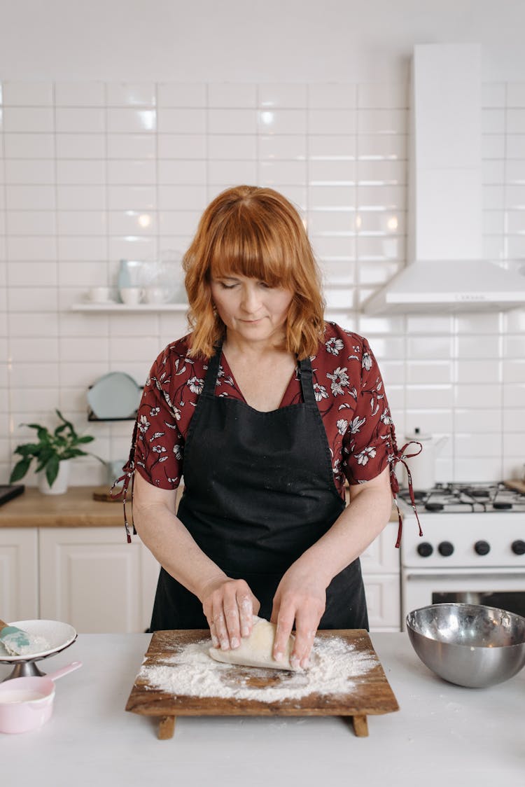 A Woman Kneading A Dough