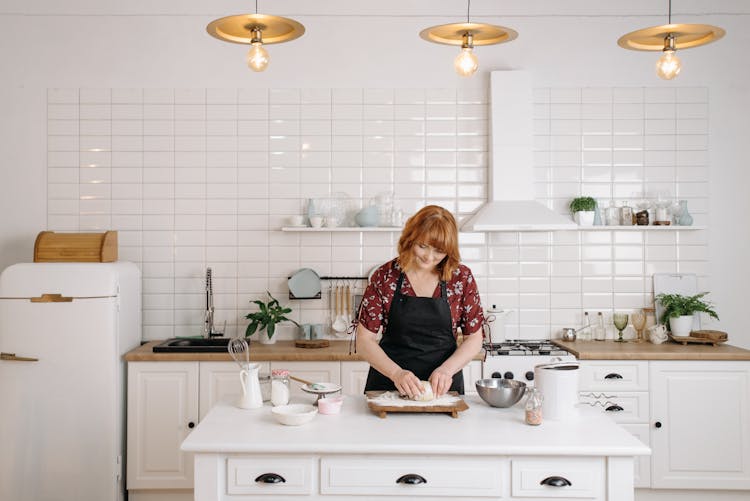 A Woman Kneading A Dough