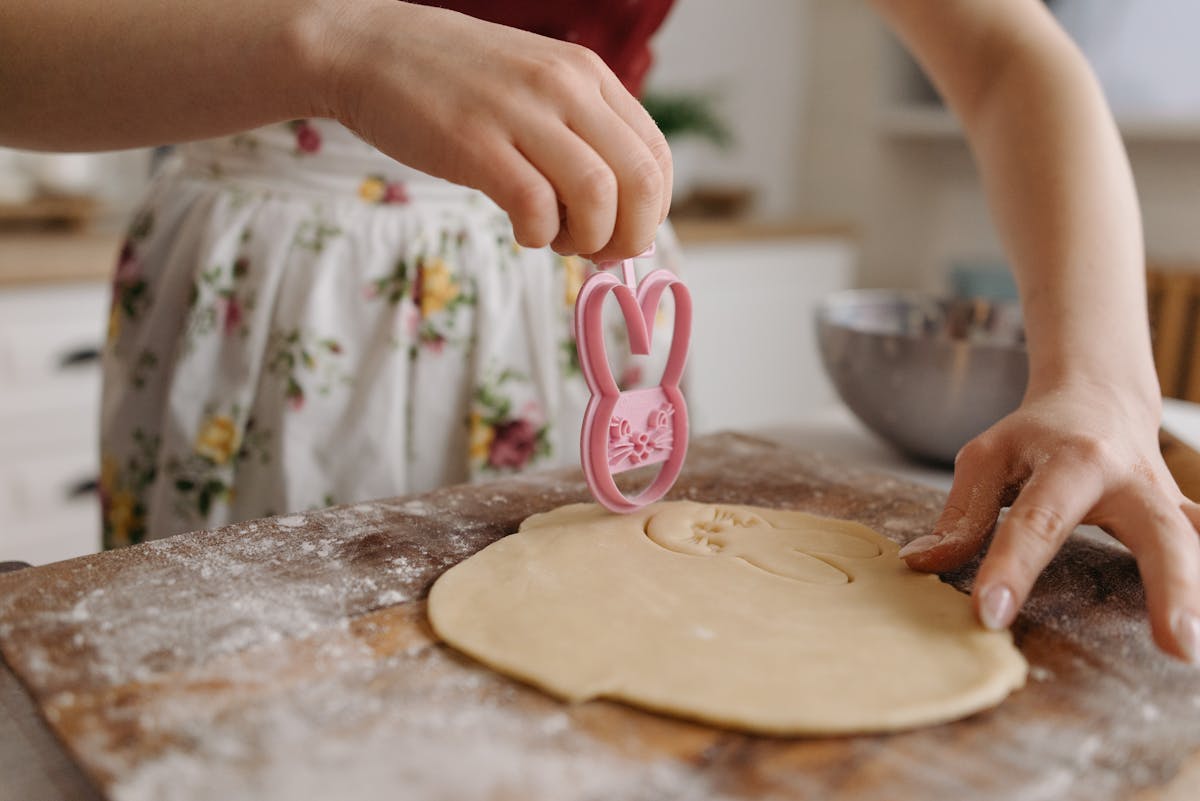 A Person Cutting a Dough with a Cookie Cutter