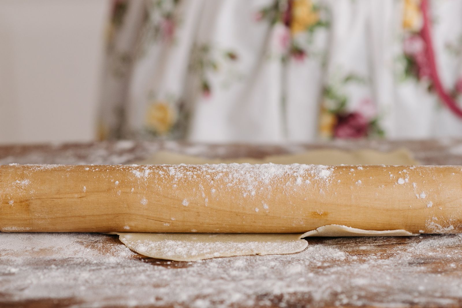 Rolling pin and dough on a floured surface