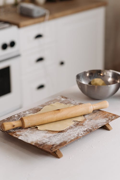 Free A Rolling Pin and a Dough on a Chopping Board Stock Photo