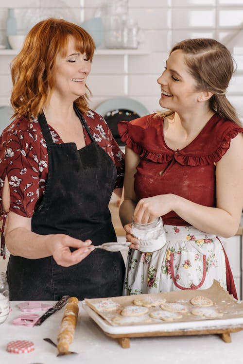 Woman in Red and White Floral Shirt Wearing Black Apron