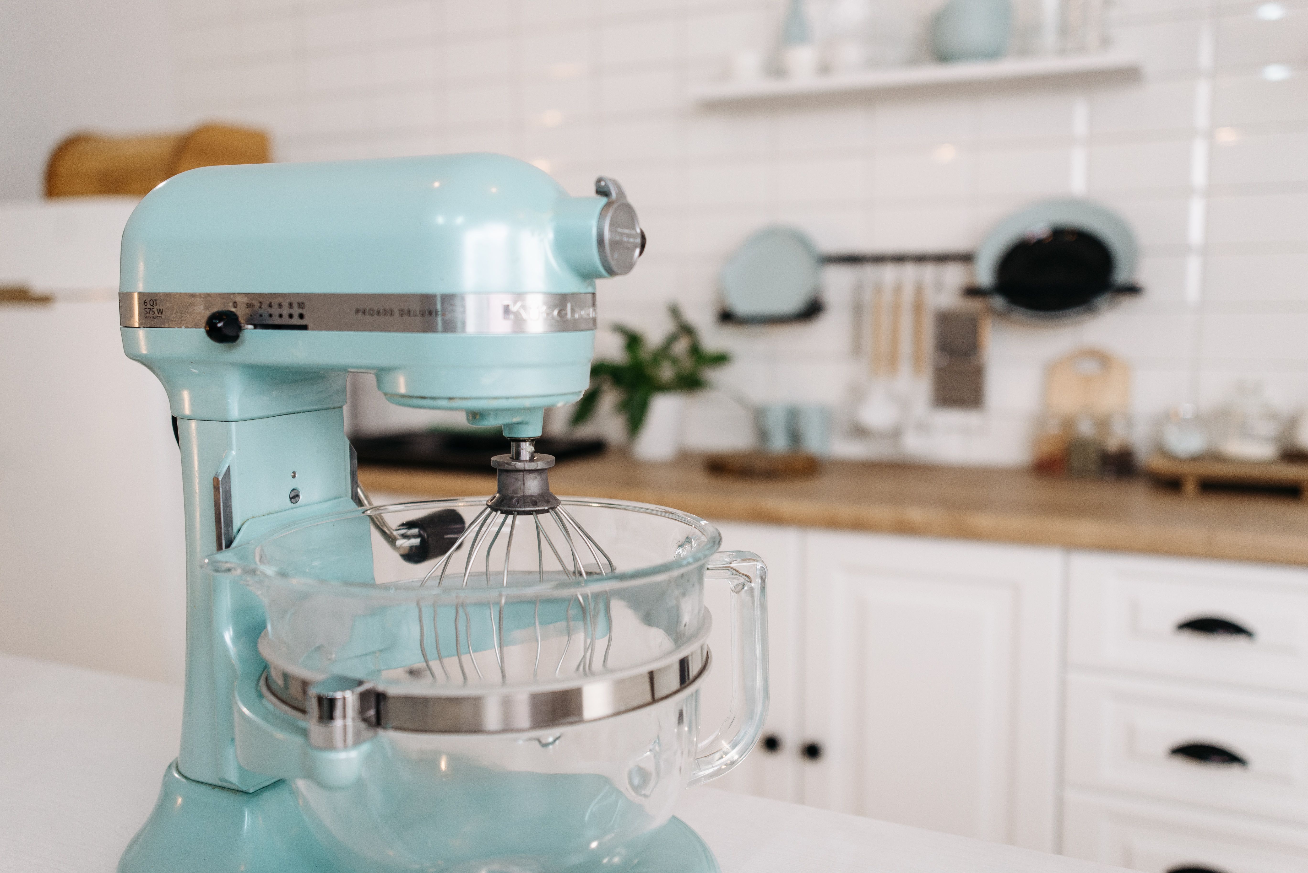 Stand mixer prepared for a measured home baking session on a clean kitchen counter