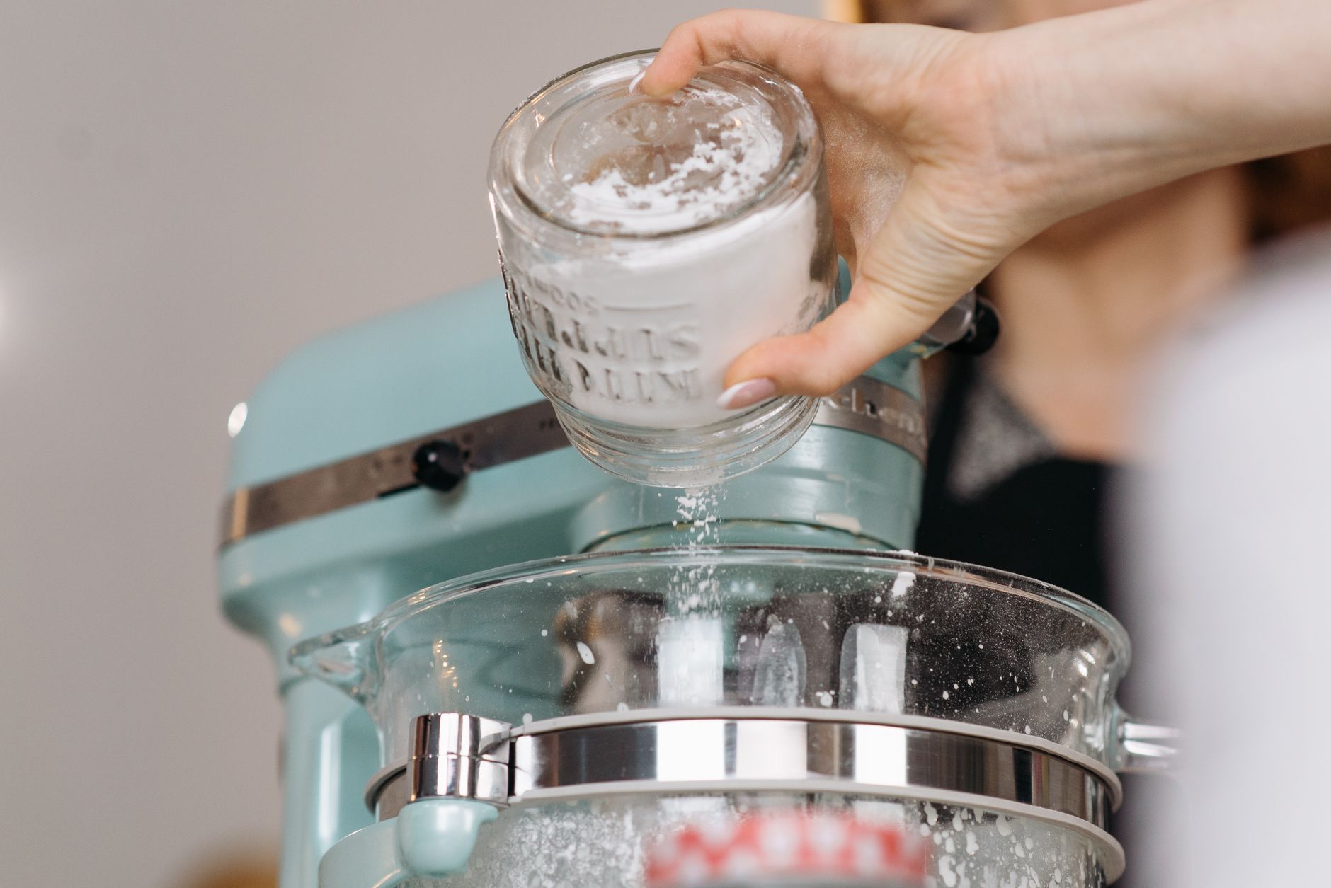 Hands cleaning vintage kitchen tools with mild detergents