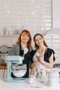 Women Standing Beside Mixer in a Kitchen