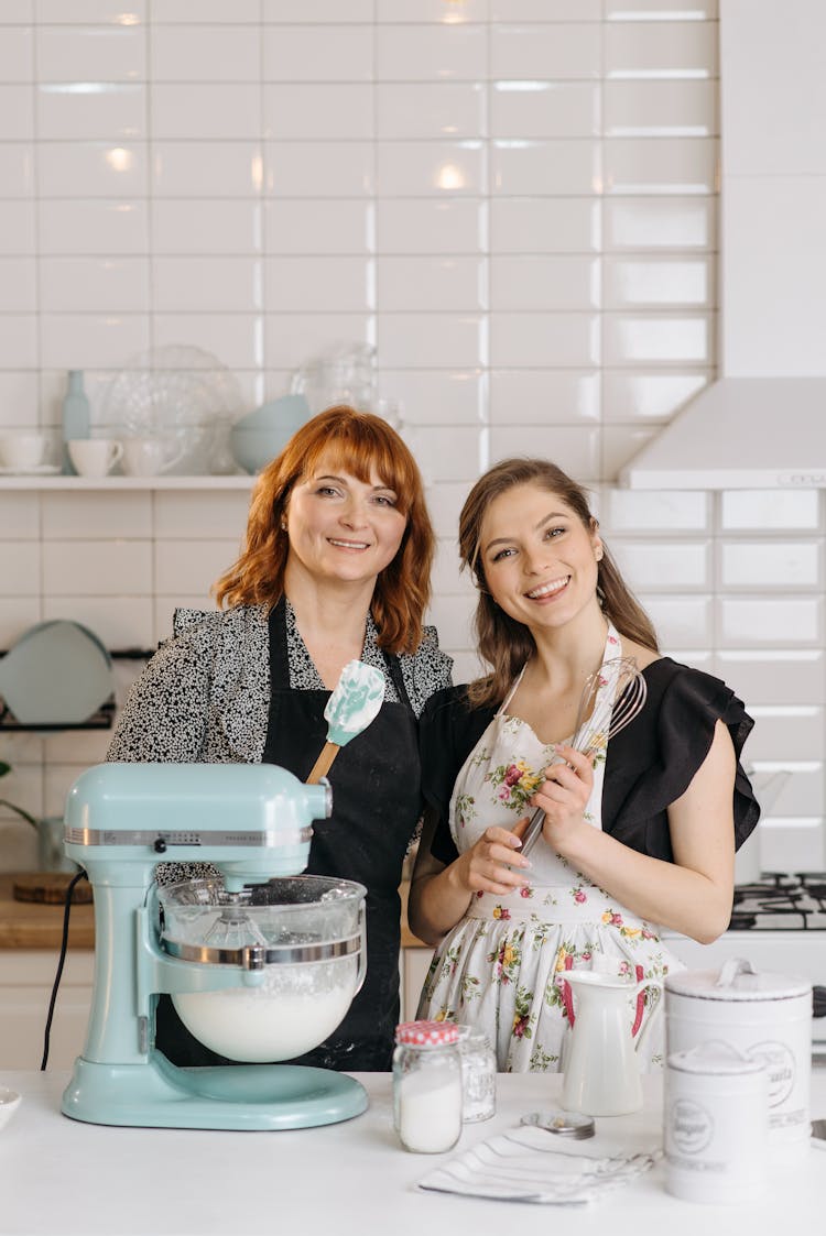 Women Standing Beside Mixer In A Kitchen