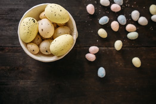 Top view of colorful Easter eggs scattered on a rustic table.