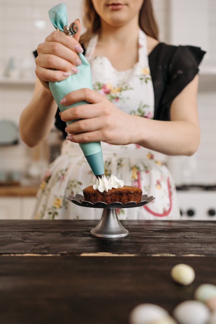 
A Baker Putting Icing On A Cake