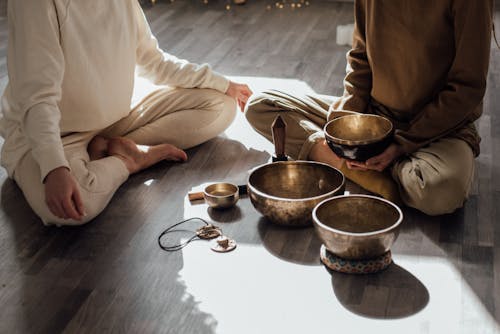 Free Women Sitting on Floor Doing Meditation and Relaxation Stock Photo