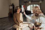 A Person Striking a Singing Bowl on the Head