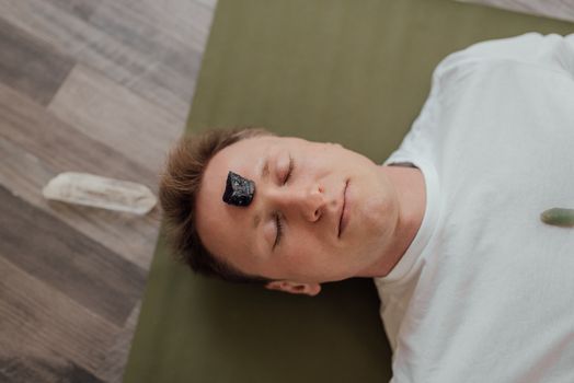 Man with Black Tourmaline Crystal on Forehead