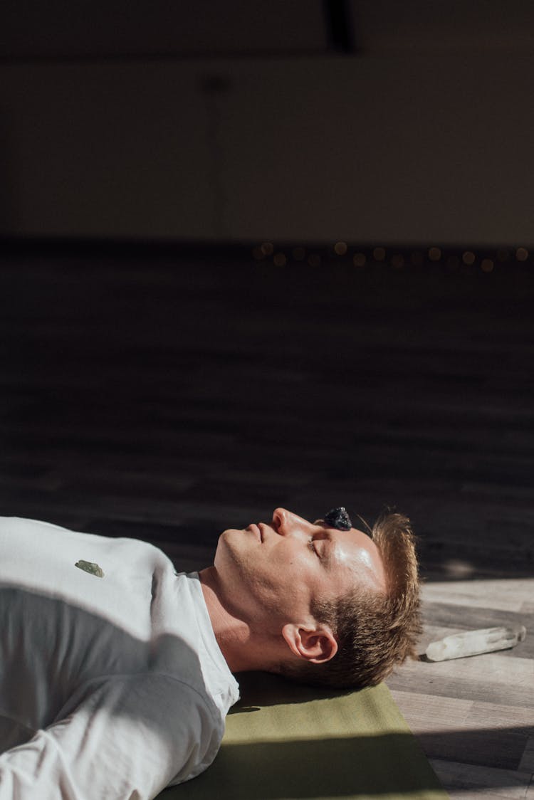 Man Lying Down With Healing Crystals