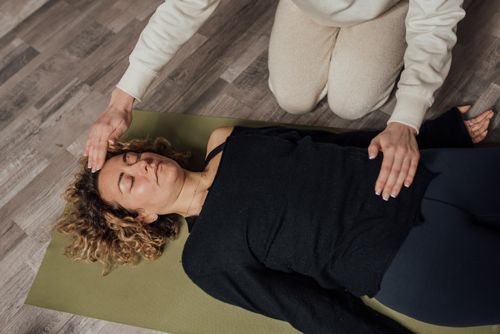 Free A woman practices holistic healing with eyes closed, focusing on relaxation and wellness. Stock Photo