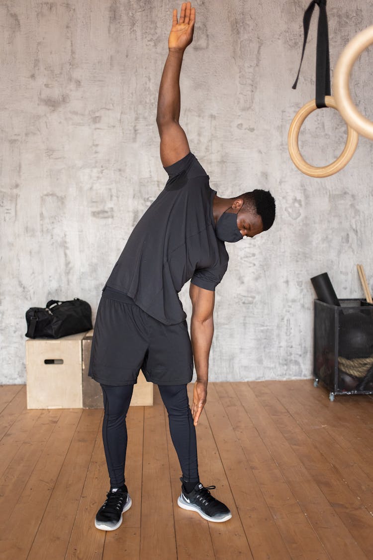 Black Man In Mask Doing Exercises In Gym