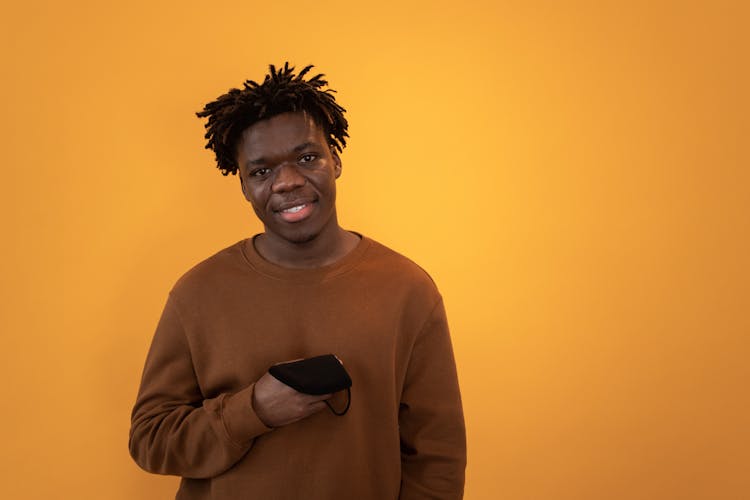 Happy Black Man With Protective Mask In Hand