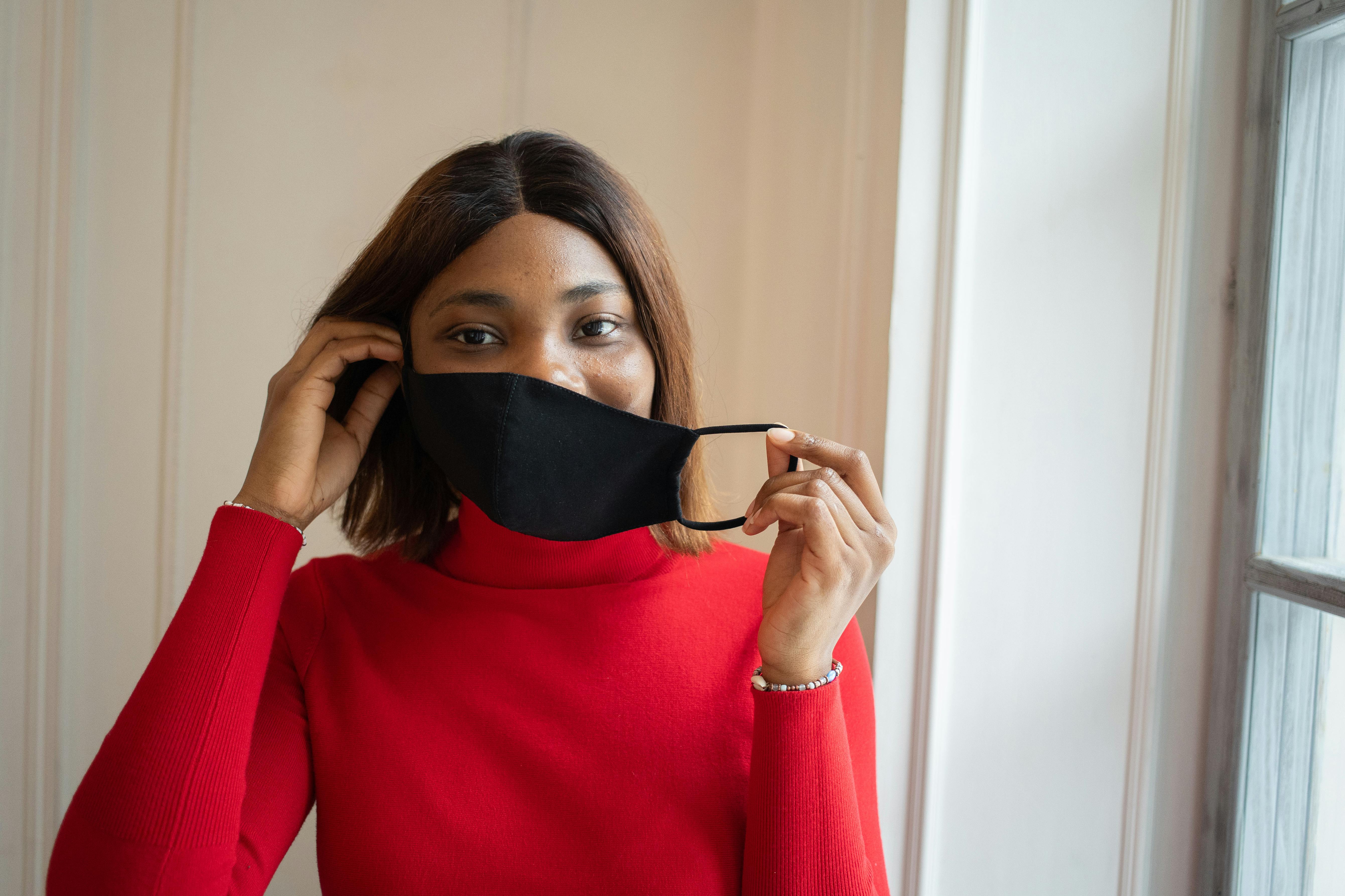 woman in protective mask in light room