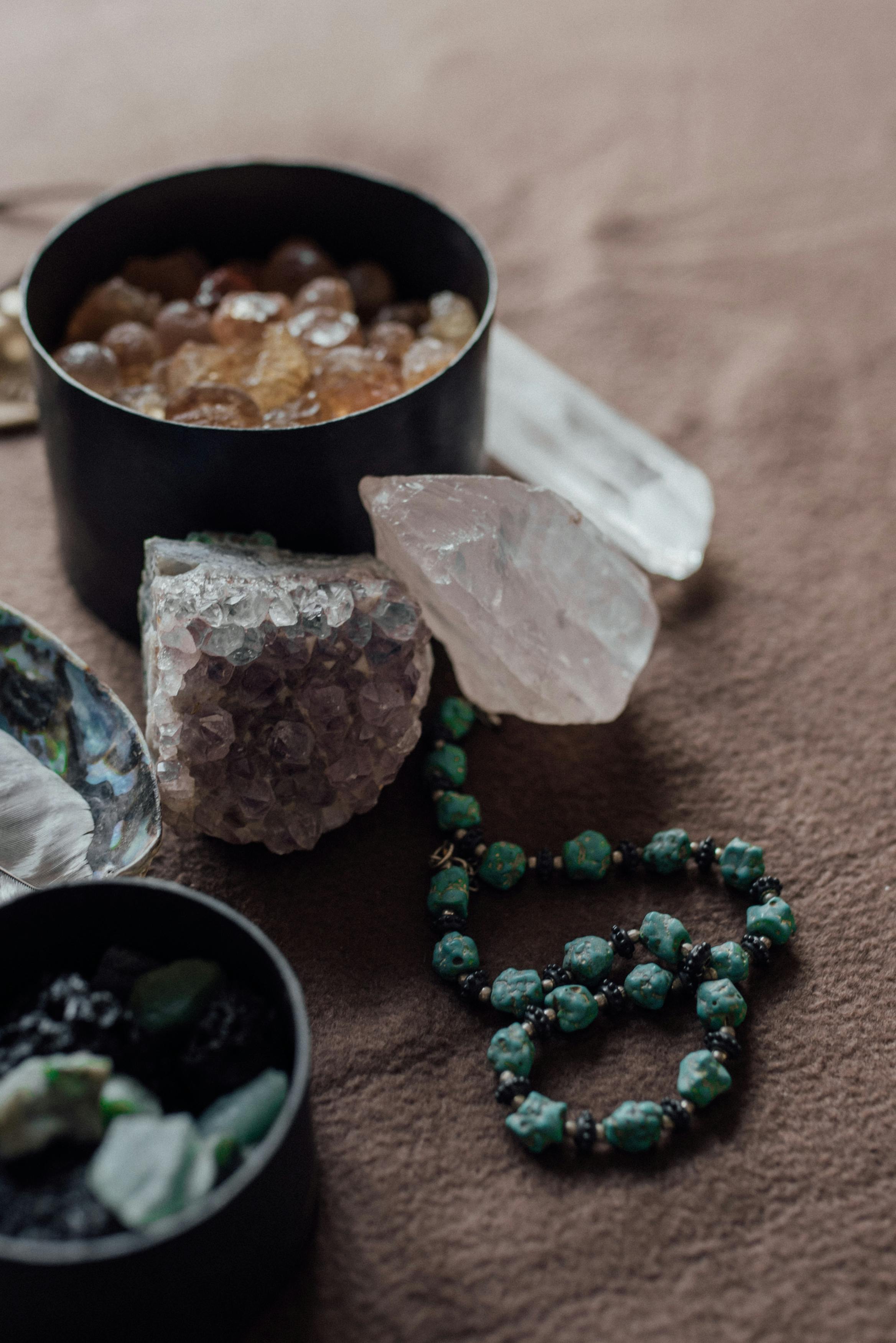 Free Detailed close-up of various crystals and gemstones artfully arranged on soft fabric in natural light. Stock Photo