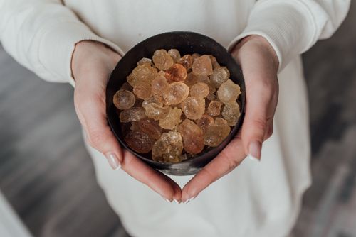 Free A close-up view of hands holding a bowl of natural healing crystals. Stock Photo