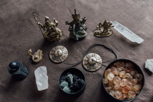 Free Collection of spiritual objects including crystals and bronze figurines used for healing and rituals. Stock Photo