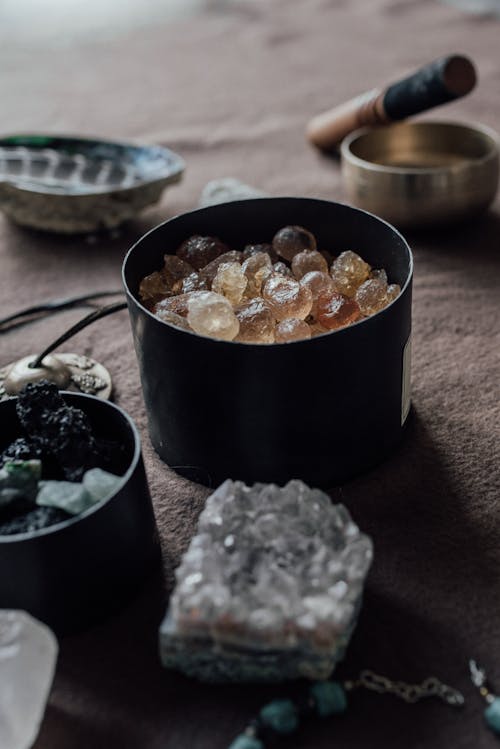 A Black Round Container with Crystals