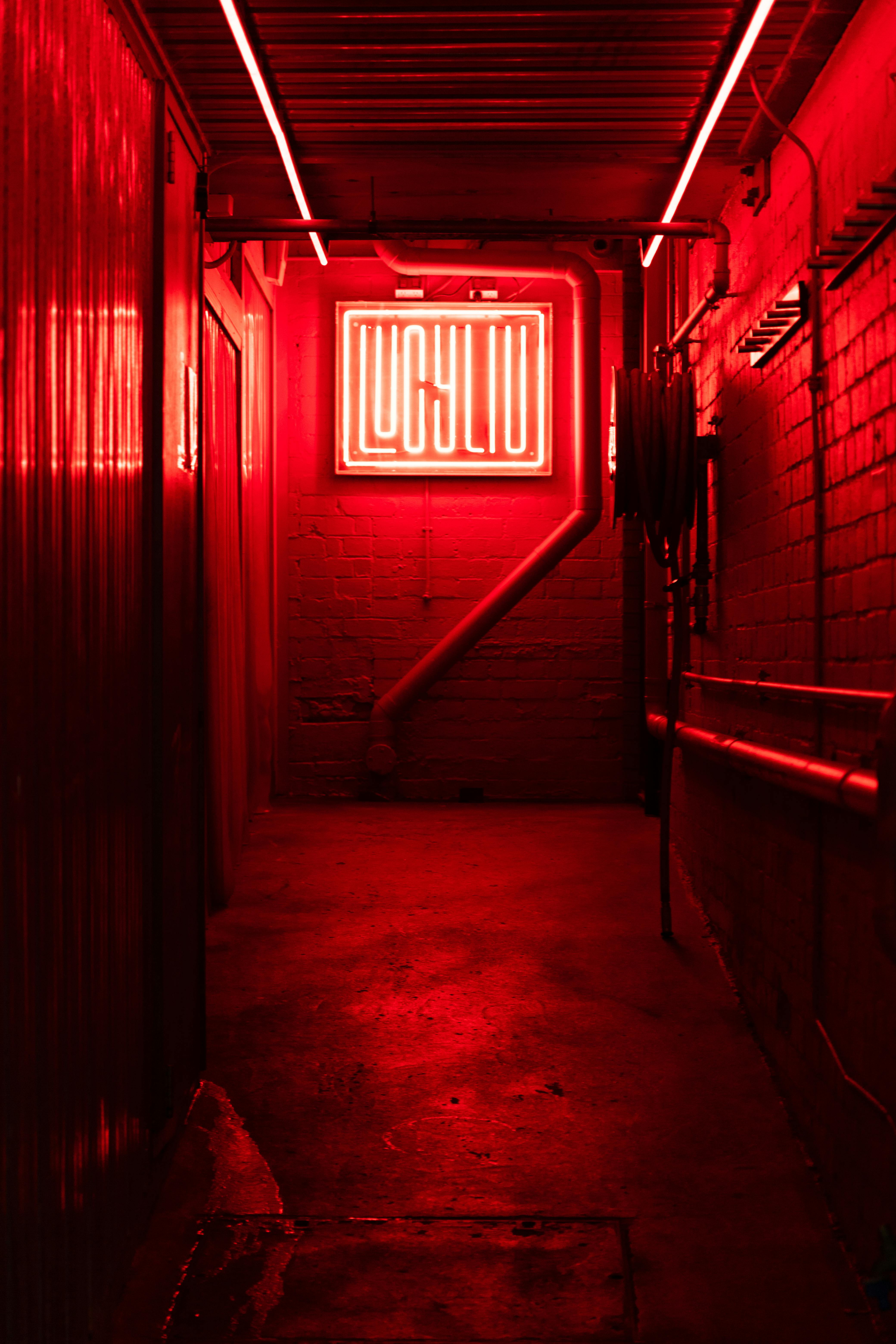 Atmospheric indoor view with intense red neon lighting in a narrow passage