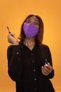 Surprise black woman with mascara standing on brown background