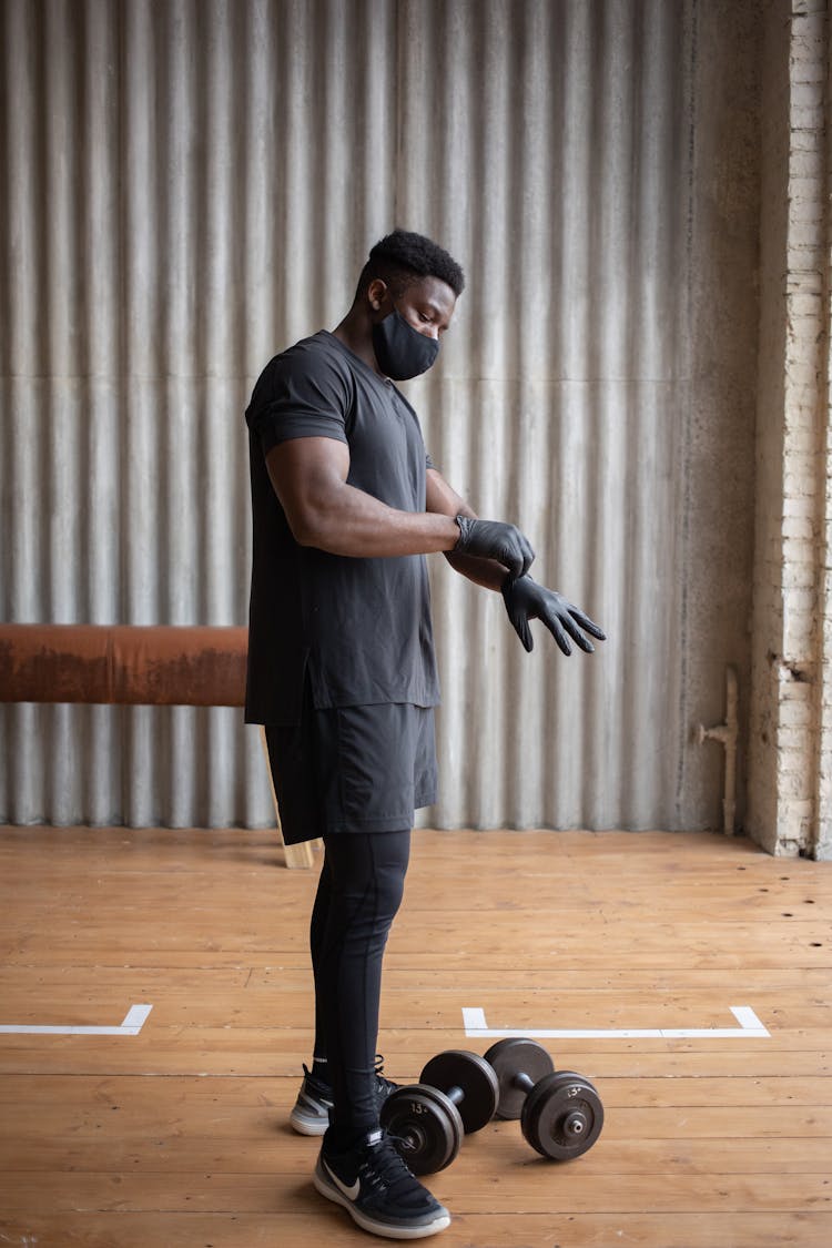 Black Man In Protective Mask And Gloves Training In Gym