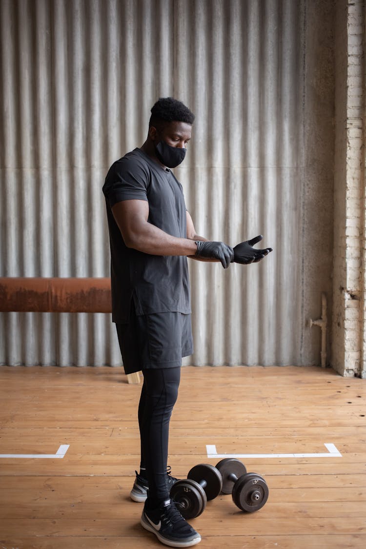 Black Sportsman In Protective Mask Training In Gym