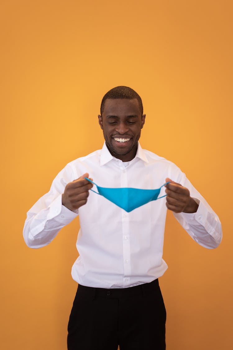 Smiling Black Businessman With Fabric Mask During Coronavirus Pandemic